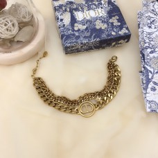 Christian Dior30 Montaigne antik sárgaréz CD logós kör medál műszálas többláncos karkötő